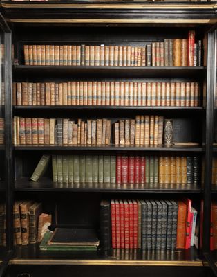 a bookcase with many books on top of it