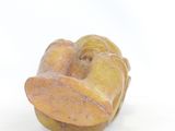 a small figurine of a banana on a white surface