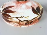 a white plate with a pink and brown design on it