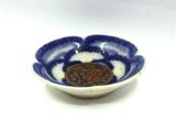 a blue and white bowl with a flower design on it