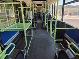 the inside of a public transit bus with a row of bunk beds