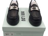 they are two pairs of black and white shoes on top of a box