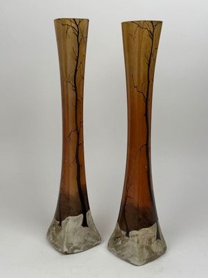 two vases that are sitting side by side on a white surface
