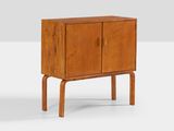 the sideboard is made of wood and has two doors and two legs