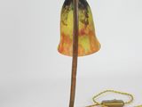 an image of a lamp that is on a stand with a rope