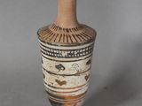 a vase that is sitting on a table with a gray background