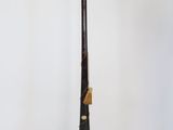a black and gold stick on a white table