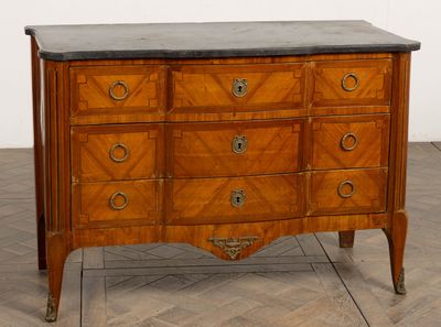 a wooden chest of drawers with a marble top