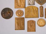 a lot of gold and silver medals on a white surface