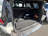 the back of a car with the trunk open and a gun in the trunk