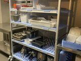 a metal shelf with a bunch of dishes on it