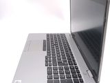 a silver laptop with a black keyboard on a white surface