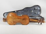 an old violin case with a violin on top of it