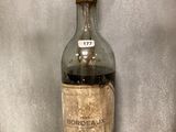 a bottle of liquor on display in a glass case