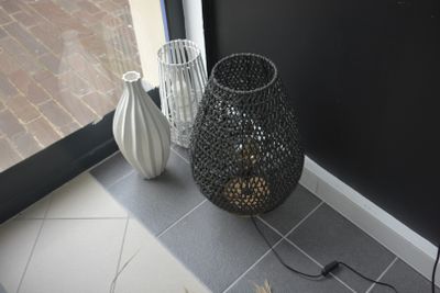 two vases sitting on the floor next to a door