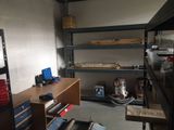 a room that has a lot of shelves and tools on it