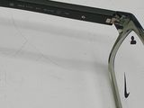 a pair of glasses sitting on a white surface
