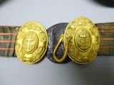 a belt that has two gold buckles on it