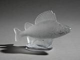 a glass fish that is sitting on top of a table