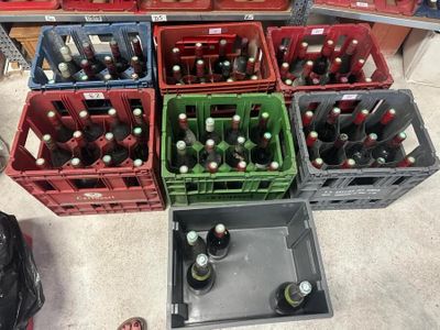 many crates of beer on the floor in a store