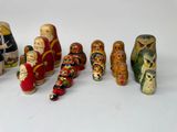 a lot of wooden dolls that are lined up together