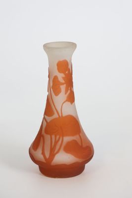 a small vase with an orange and white design on it
