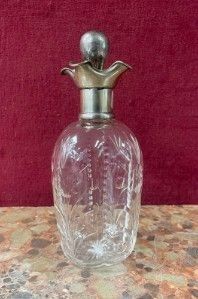 a glass bottle with a metal lid on a table