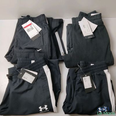 four pairs of black and white pants with tags on them