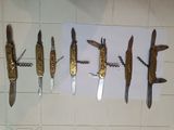 many different types of knives hanging on a wall