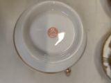 a white plate with a red design on it sitting on a table