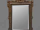 an ornate gold framed mirror with a crown on top of it