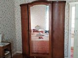 a bedroom with a bed, dresser, and mirror in it