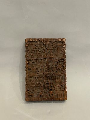 an image of a piece of wood with carvings on it on a white surface