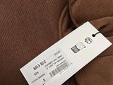 the label on the back of a brown sweater shows the price of the item