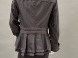 the back of a mannequin wearing a gray jacket and pants