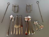 many spoons, forks, and spoon spoons laid out on a table