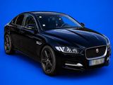 a black jaguar parked in front of a blue background