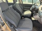 the interior of a car with grey seats and a steering wheel