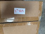 a cardboard box with a sticker on it sitting on the floor