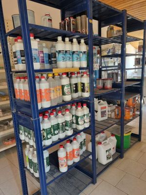 many bottles and containers on the shelves in the store