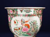 a large vase with a bird and flowers on it