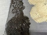 two pieces of lace on a piece of fabric on a table