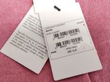 two tags attached to a pink cloth with a barcode