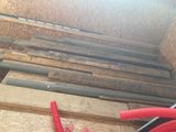 a pile of wood and a hose on the floor