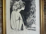 a framed picture of a woman sitting on a wall