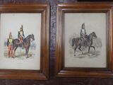 two framed pictures of men in uniforms riding horses on a wall