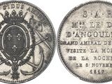 a close up of a silver coin with a crown on it
