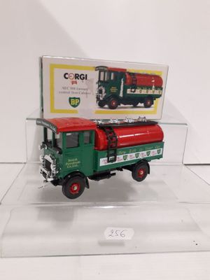 a green and red truck with a box on the back of it