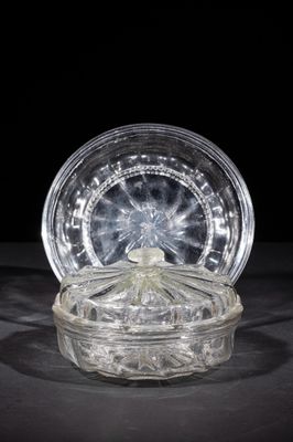 a clear glass container with a lid on a table