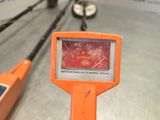 an orange sign that is on the side of a pole